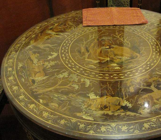 photo of table top with lion inlay in wood