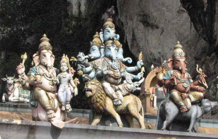 Painted Hindu god statues on temple wall