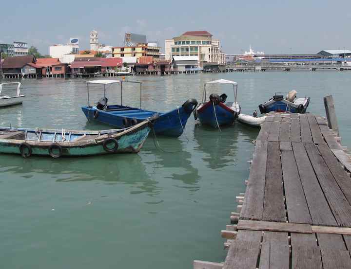 Boats tied to pier